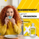Person isst ein Gebäck; daneben Maaloxan® Suspension – 250ml Flasche – Minze mit der Aufschrift „Sodbrennen? Jetzt probieren.“